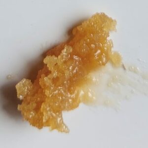 A sample of honey shown on a cutting board.